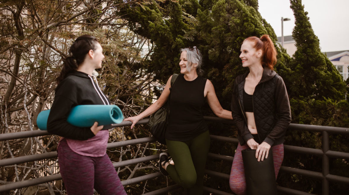 Three woman laughing together after going to the gym