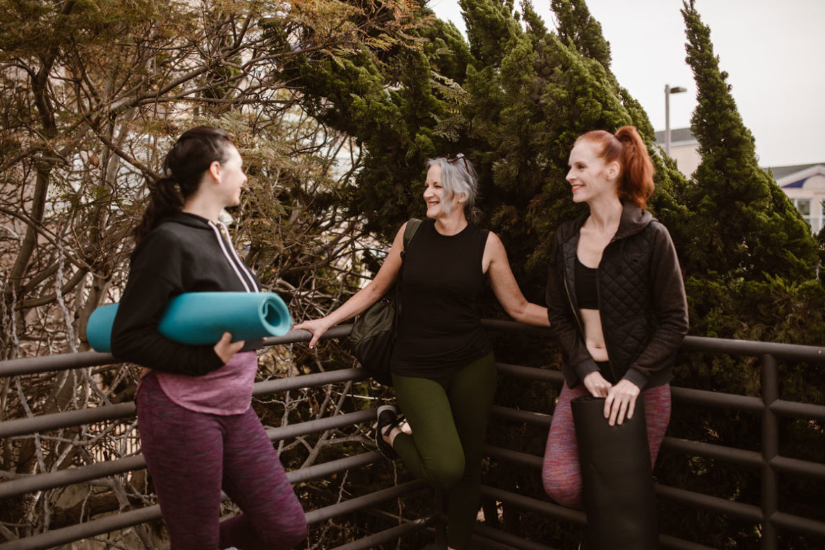 Three woman laughing together after going to the gym