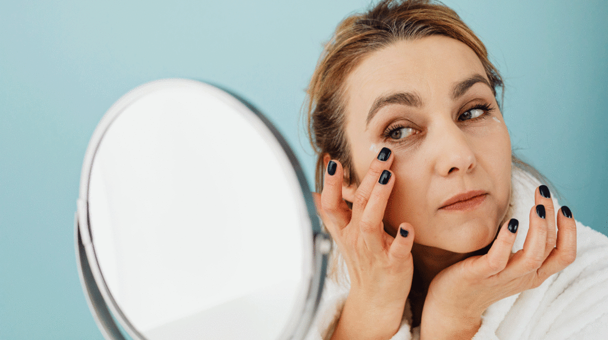 Woman using eye cream for dark circles