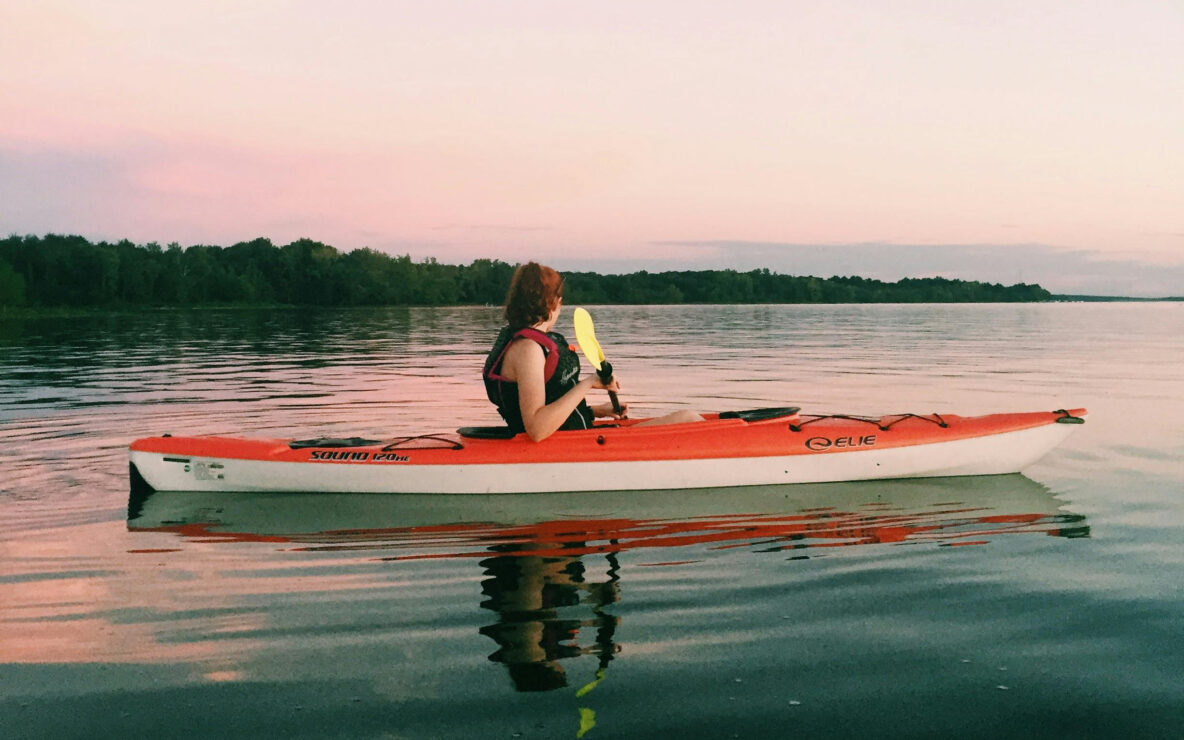 Woman on kayak on lake